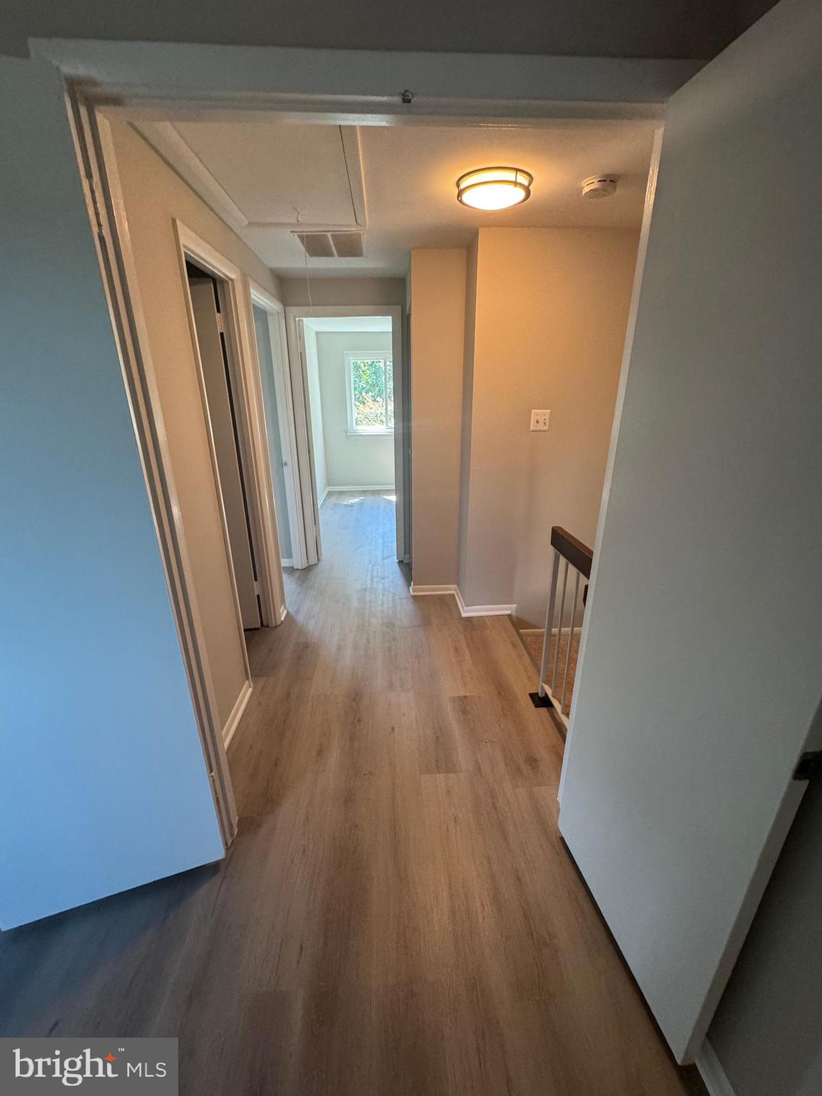 8958 Centerway Road Gaithersburg, MD 20879 - Photo 26 of 37 a view of a hallway with wooden floor and staircase