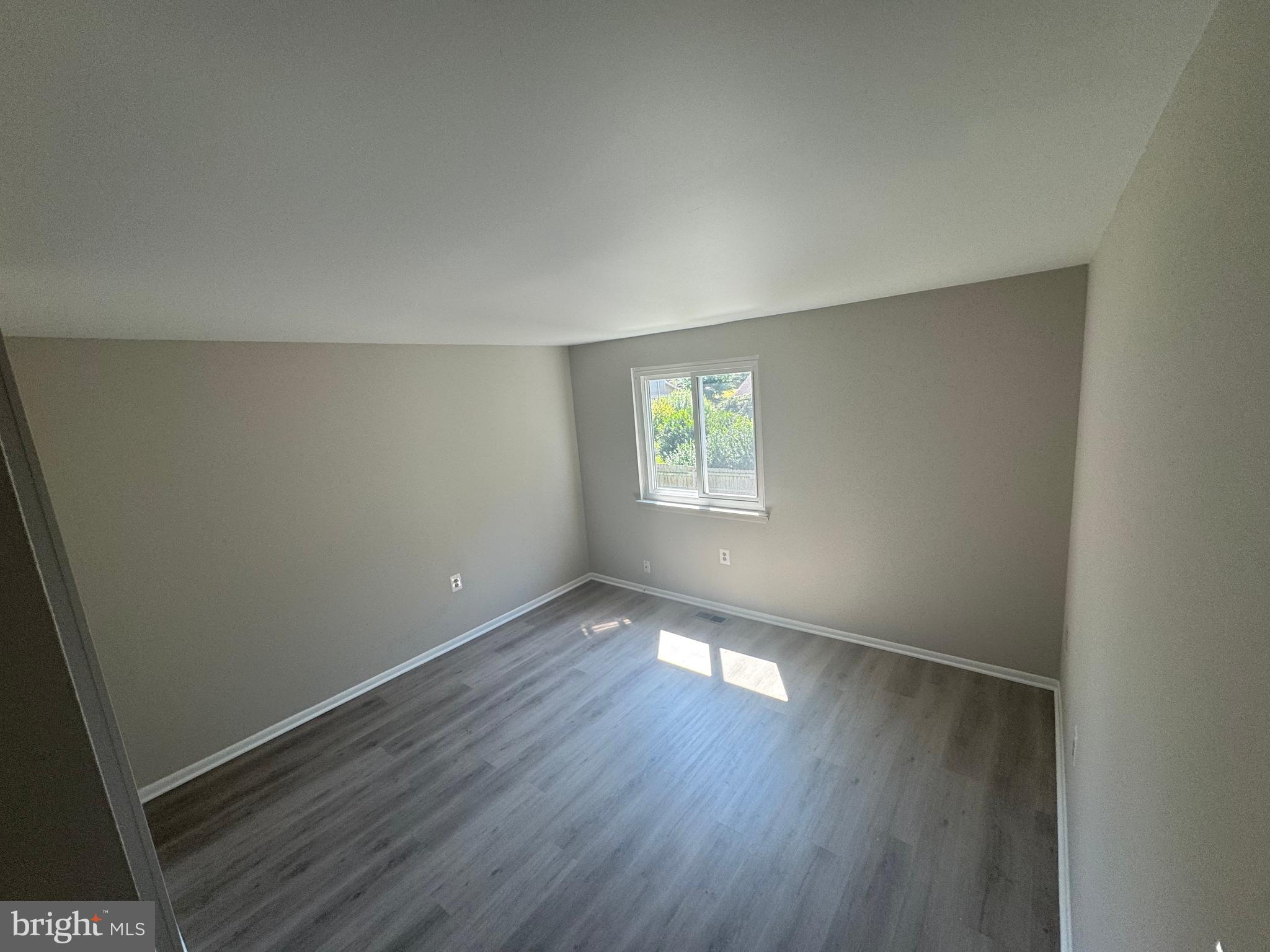 8958 Centerway Road Gaithersburg, MD 20879 - Photo 29 of 37 an empty room with wooden floor and windows