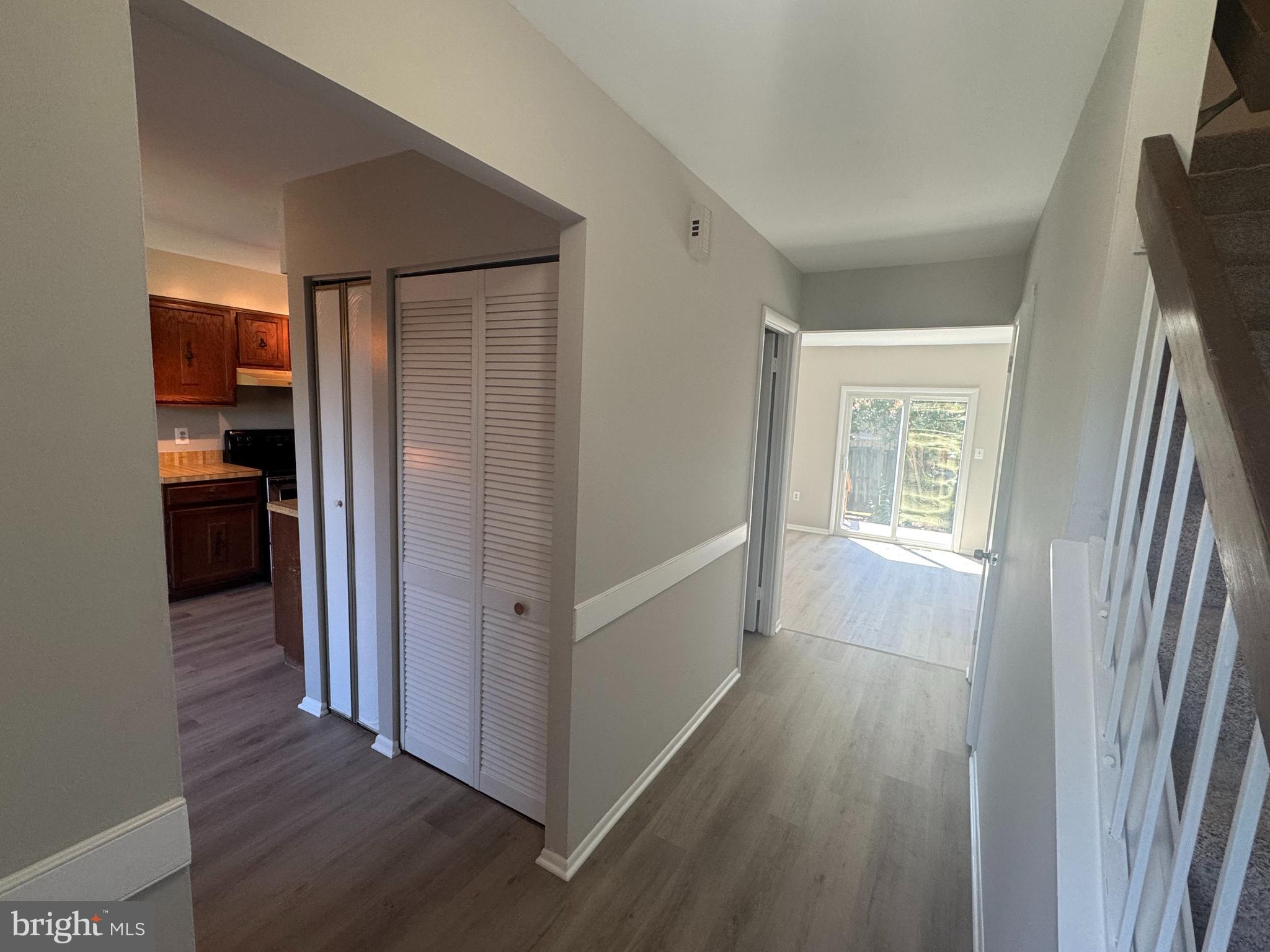 8958 Centerway Road Gaithersburg, MD 20879 - Photo 6 of 37 a view of a hallway with wooden floor and cabinet