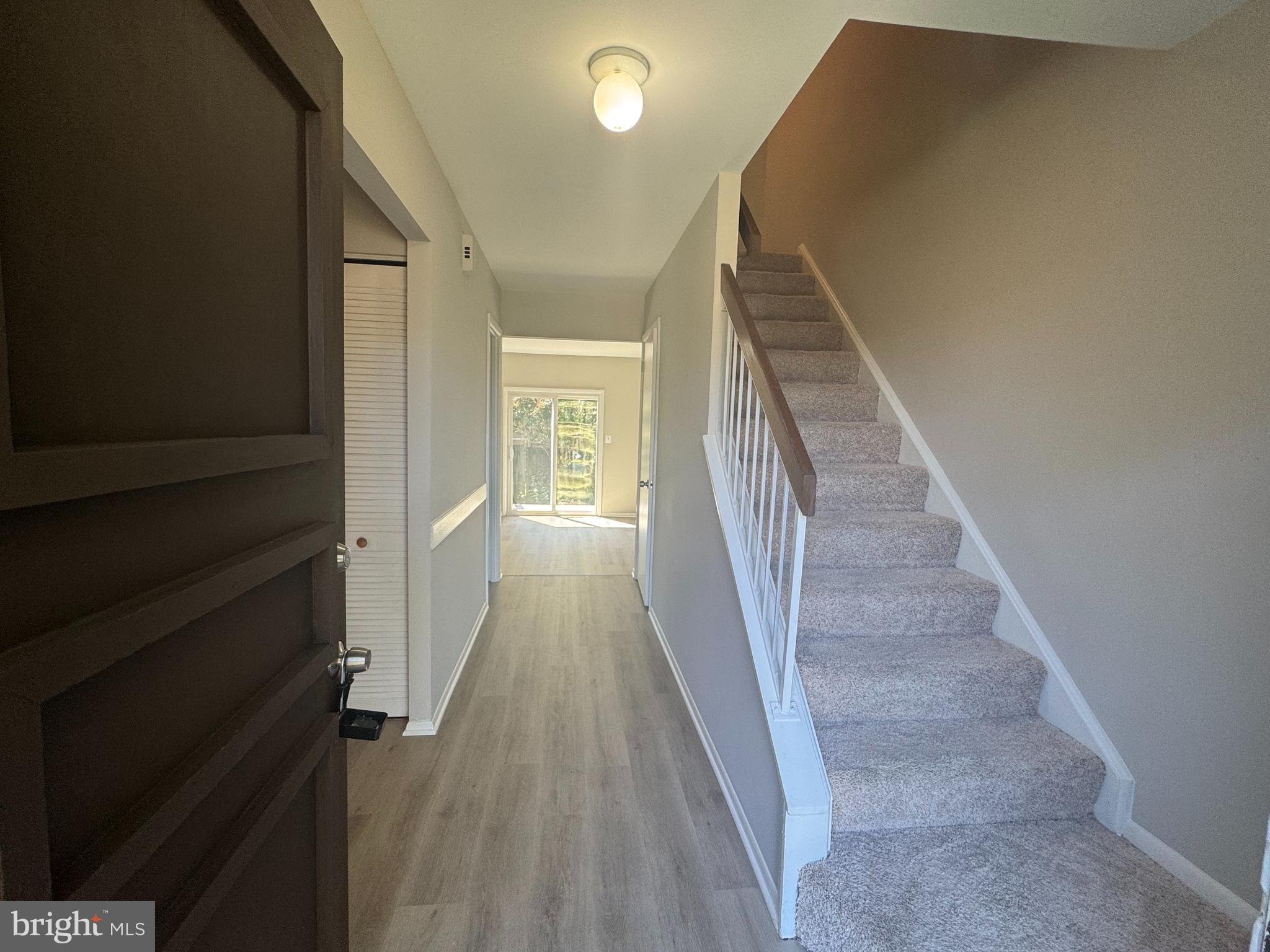 8958 Centerway Road Gaithersburg, MD 20879 - Photo 7 of 37 a view of a hallway with wooden floor and staircase