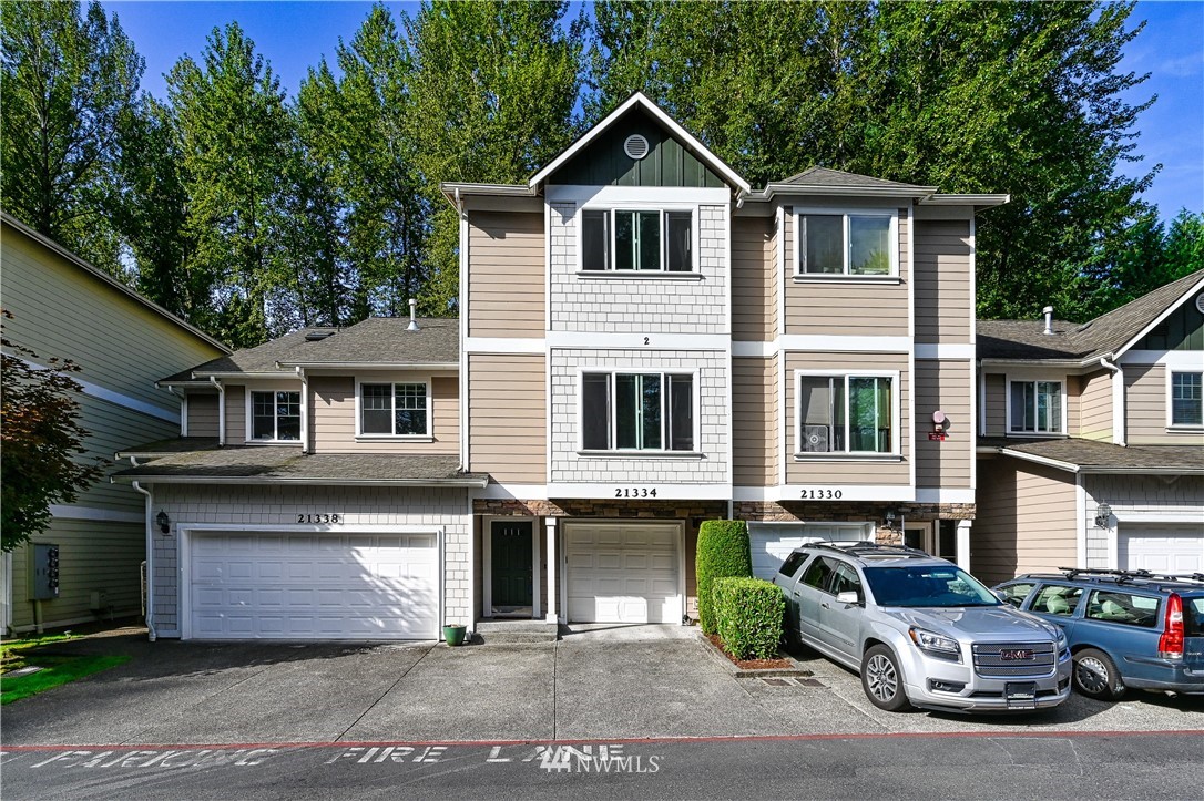 21334 11th Drive Southeast Bothell, WA 98021 - Photo 1 of 29 a front view of a house with garage and parking