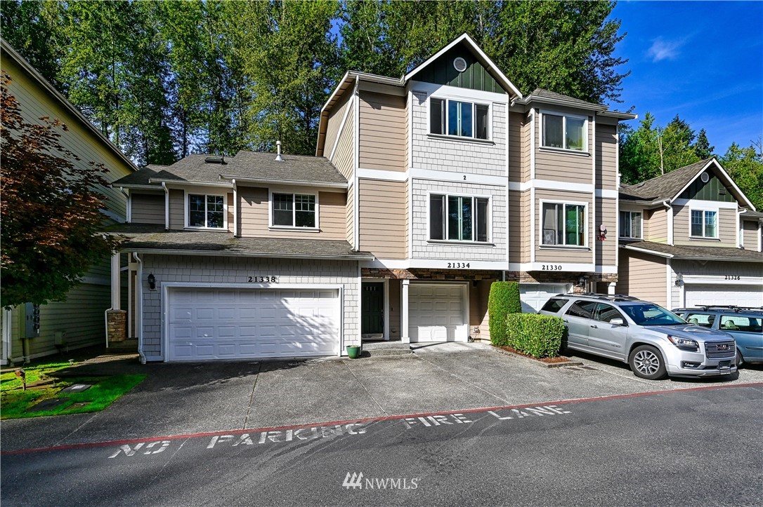 21334 11th Drive Southeast Bothell, WA 98021 - Photo 2 of 29 a front view of a house with a yard and garage
