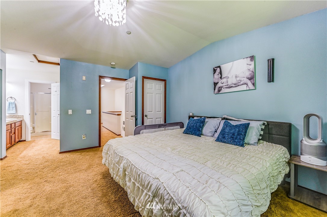 21334 11th Drive Southeast Bothell, WA 98021 - Photo 17 of 29 a large bed sitting in a bedroom and a bathroom