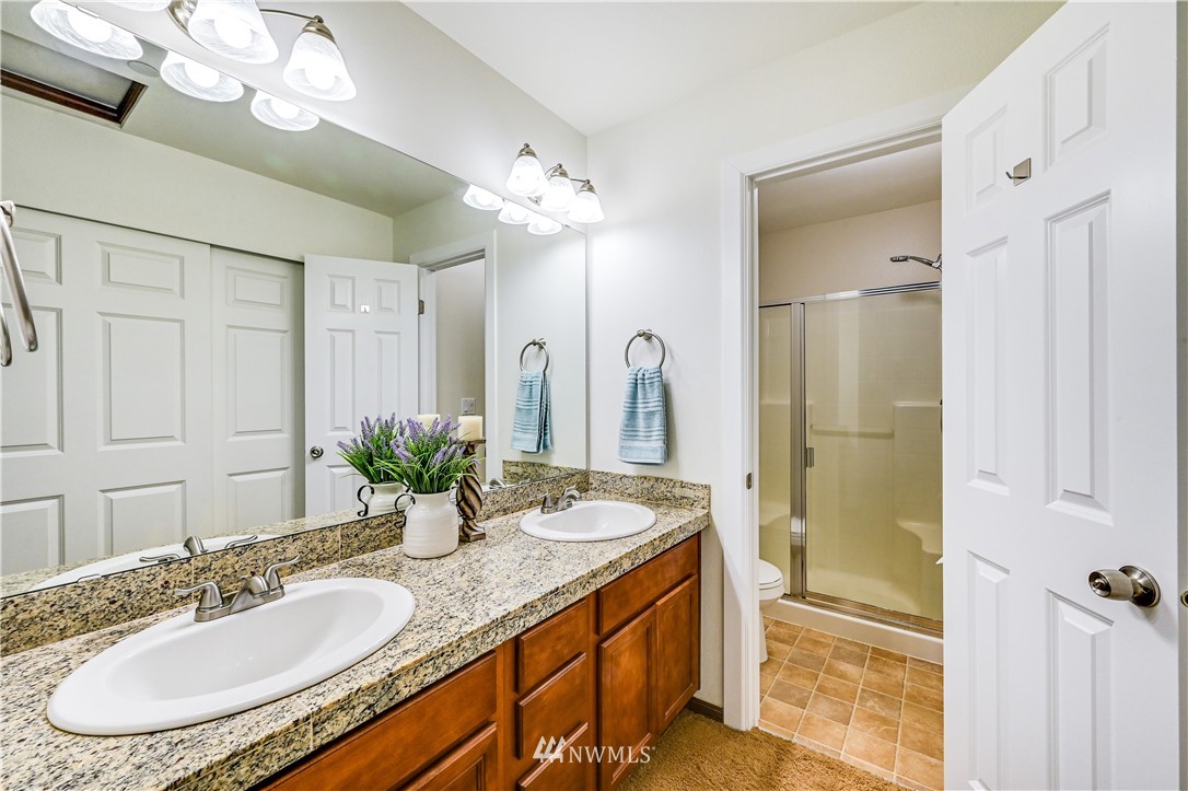 21334 11th Drive Southeast Bothell, WA 98021 - Photo 18 of 29 a bathroom with a granite countertop double vanity sink mirror and shower