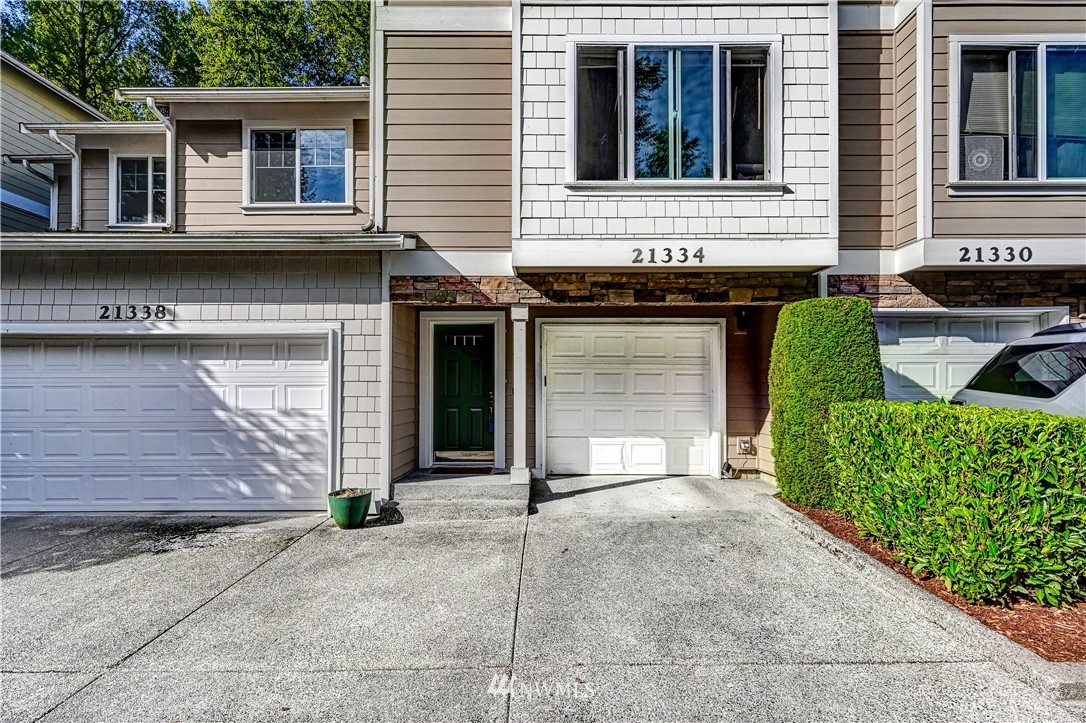 21334 11th Drive Southeast Bothell, WA 98021 - Photo 3 of 29 a front view of a house with garden