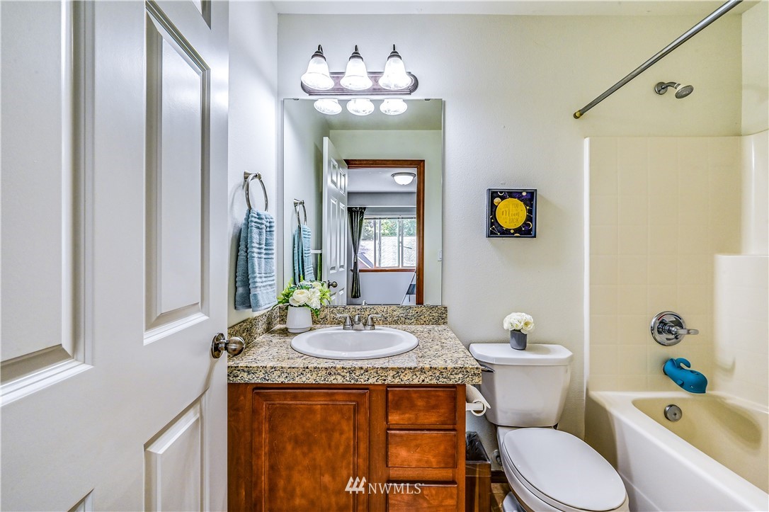 21334 11th Drive Southeast Bothell, WA 98021 - Photo 22 of 29 a bathroom with a granite countertop sink toilet and shower