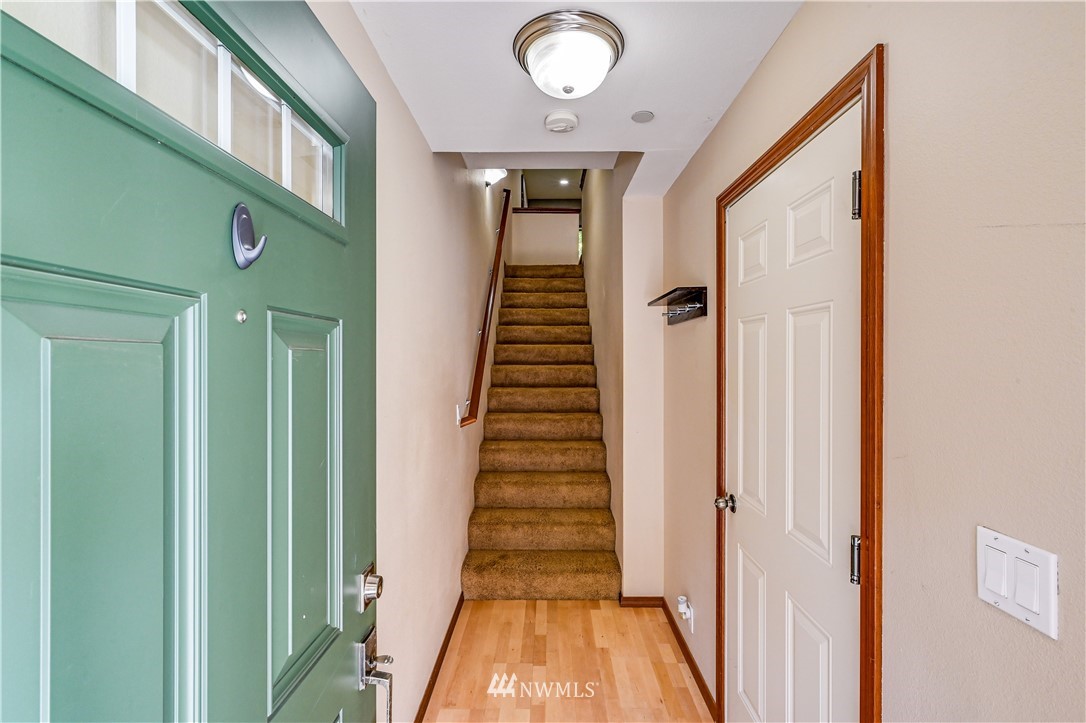 21334 11th Drive Southeast Bothell, WA 98021 - Photo 4 of 29 a view of a hallway with wooden floor and staircase