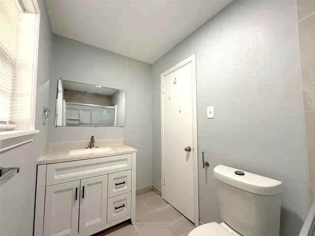 a bathroom with a sink toilet and vanity