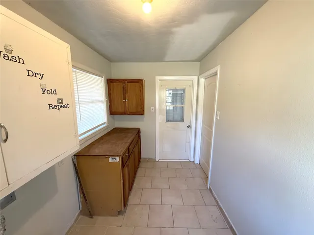 a kitchen with a refrigerator and a stove top oven