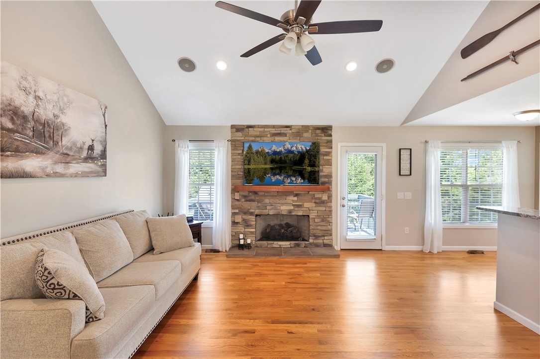 131 Morgan Road West Union, SC 29696 - Photo 2 of 39 Natural light floods this living room, featuring a beautiful stone fireplace and gleaming hardwood floors.