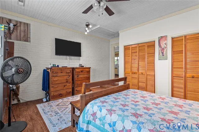 a bedroom with a bed and a television