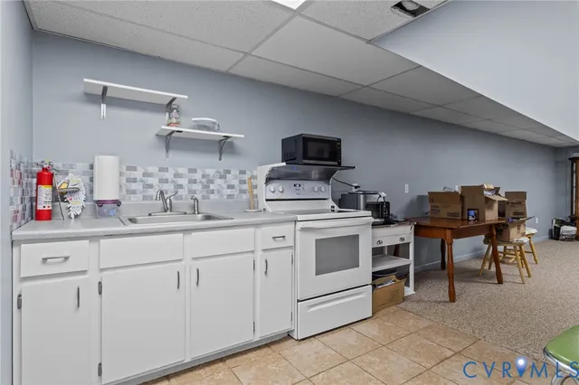 a kitchen with cabinets appliances a sink and a counter top space