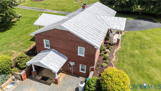 an aerial view of a house with swimming pool garden and patio