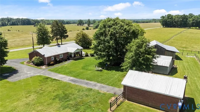 an aerial view of a house with outdoor space and lake view