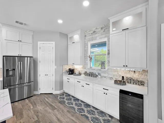 a kitchen with stainless steel appliances a refrigerator sink and microwave