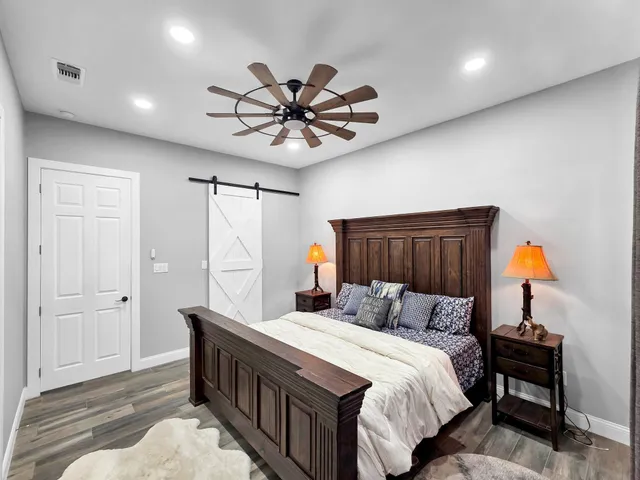 a bedroom with a bed and a chandelier