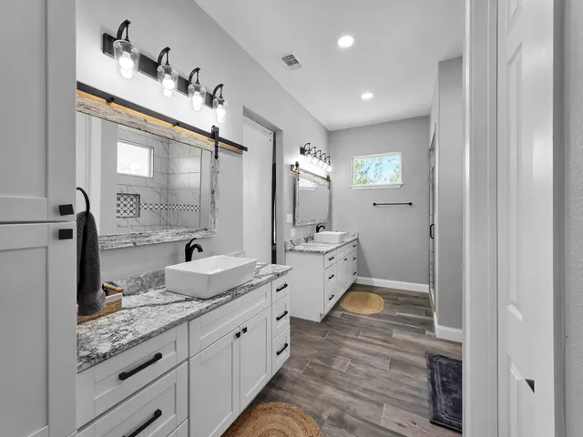 a spacious bathroom with a double vanity sink and mirror