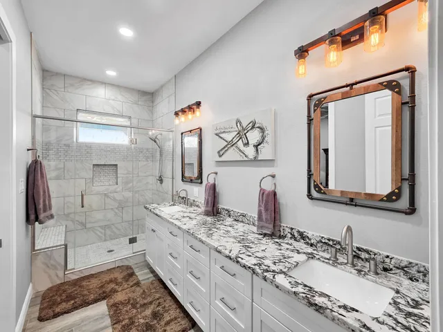 a bathroom with a granite countertop sink mirror and double