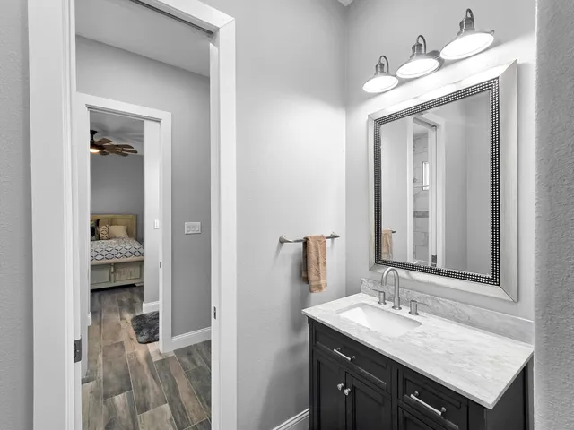 a en suite bathroom with a sink and a mirror