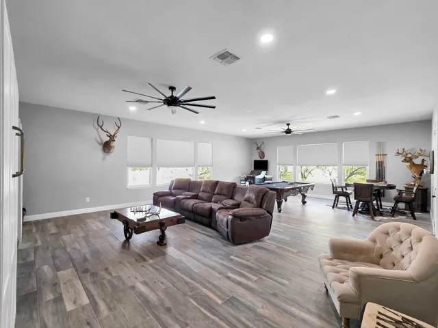 a living room with furniture and wooden floor