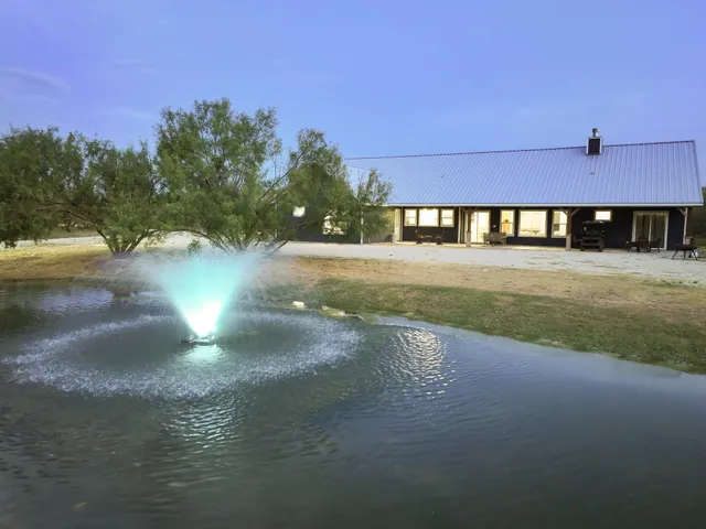 a view of a house with backyard and a yard