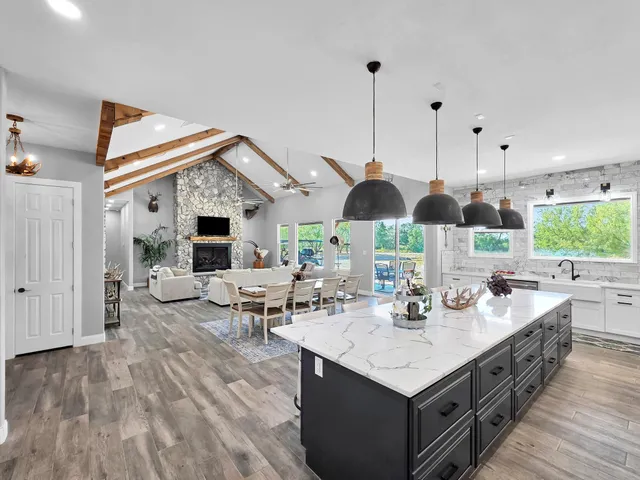 a open kitchen with stainless steel appliances granite countertop a stove and refrigerator