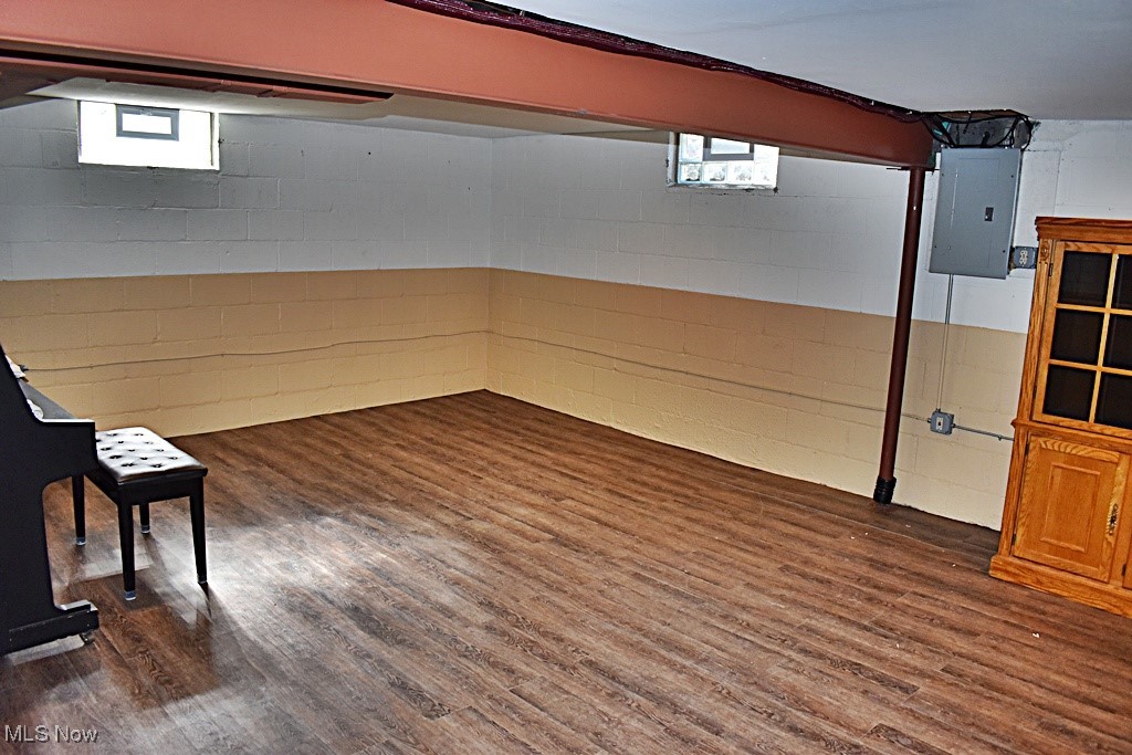17600 Egbert Road Bedford, OH 44146 - Photo 38 of 49 Basement with laminate flooring and concrete block wall, and electric panel