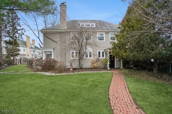 a front view of house with a garden