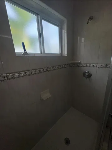 a bathroom with a sink and a window