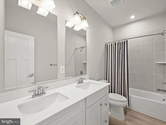 a view of a house and couches with wooden floor and city view