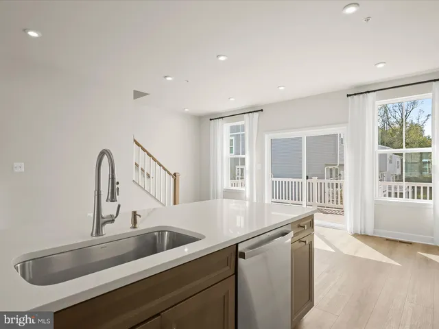 an empty room with windows and cabinet