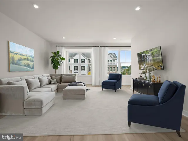 a dining room with furniture a window and wooden floor