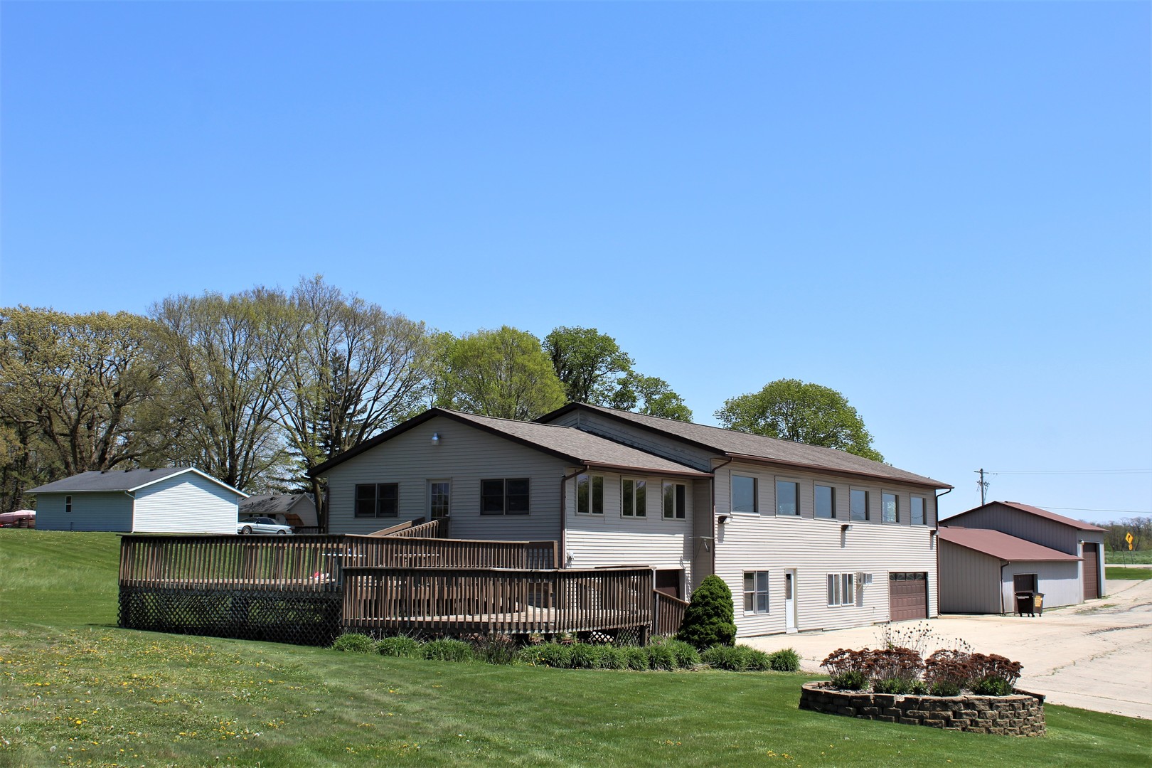 15523 Henry Road Morrison, IL 61270 - Photo 2 of 16 a front view of a house with a garden