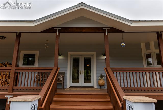 14 Apache Road Florissant, CO 80816 - Photo 2 of 15 Doorway to property featuring french doors and covered porch
