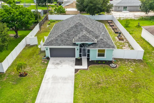 a view of a house with a yard patio and a patio