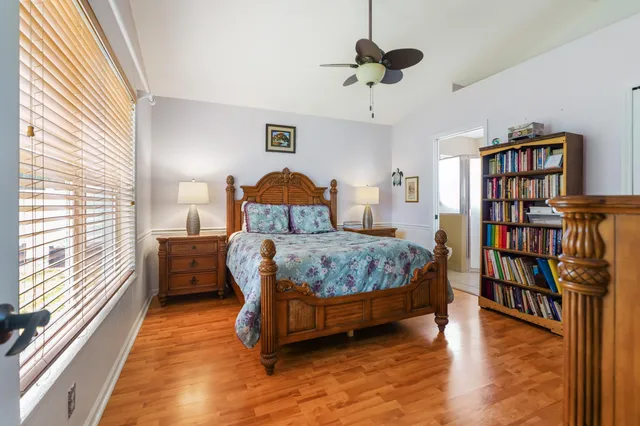 a bedroom with a bed and a book shelf