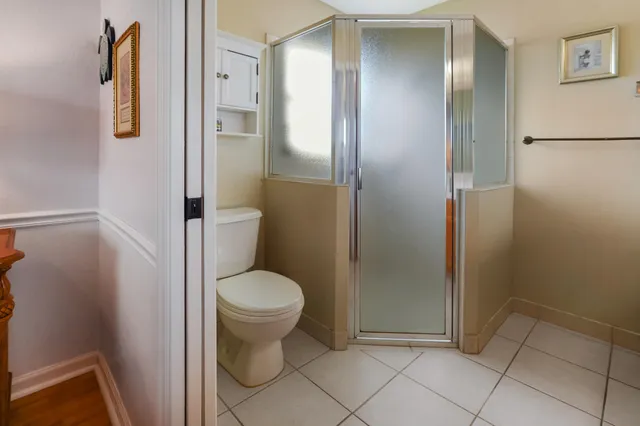 a bathroom with a granite countertop toilet and a shower