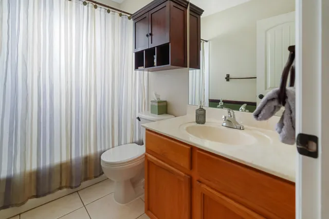 a bathroom with a sink toilet and mirror