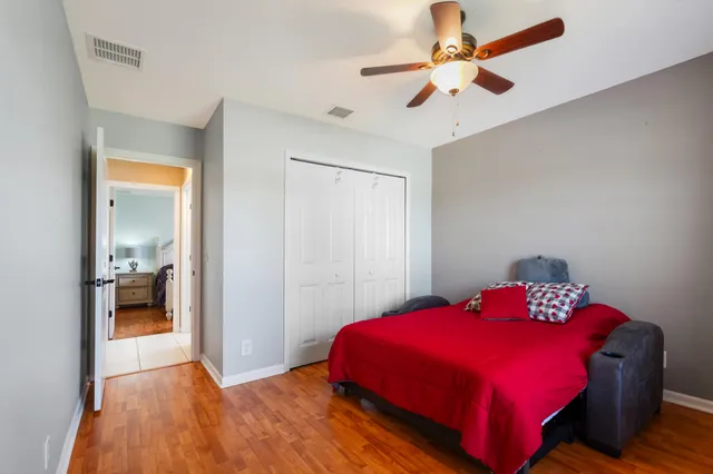a bedroom with a bed and a chandelier