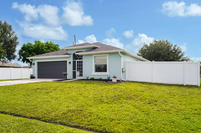 a view of a house with a yard and garage