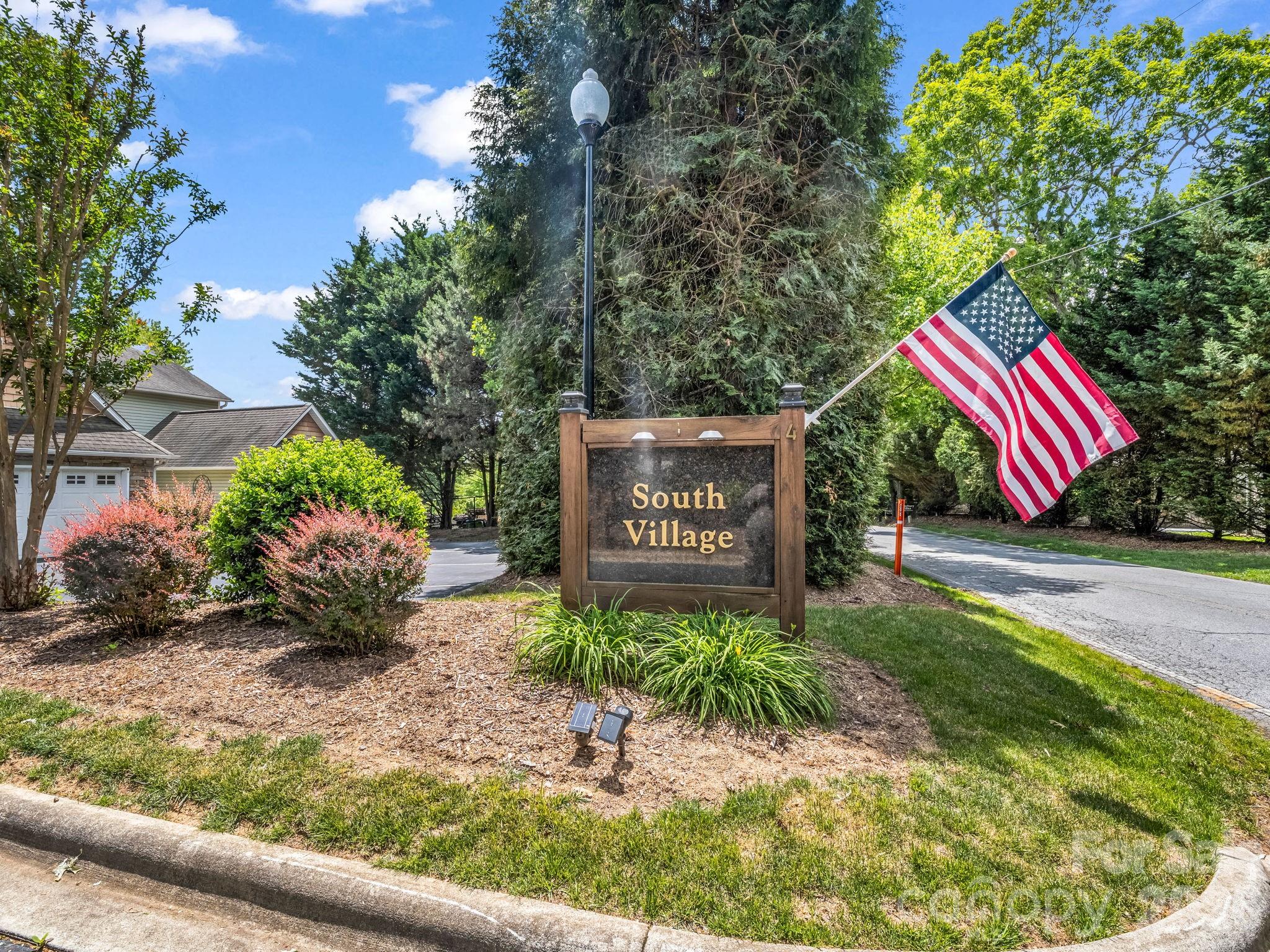 4 Rathfarnham Road, Unit 4F Asheville, NC 28803 - Photo 33 of 33 a sign that is sitting in front of flowers