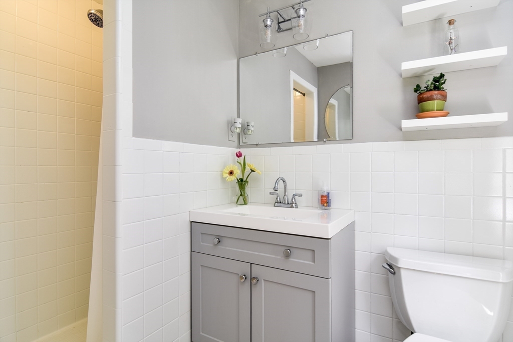 114 Hunters Ridge Road Concord, MA 01742 - Photo 24 of 38 a bathroom with a sink a toilet and mirror
