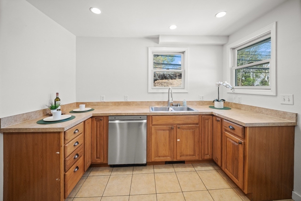 1180 Main Street, Unit 1 Waltham, MA 02451 - Photo 12 of 30 a kitchen with a sink and a stove