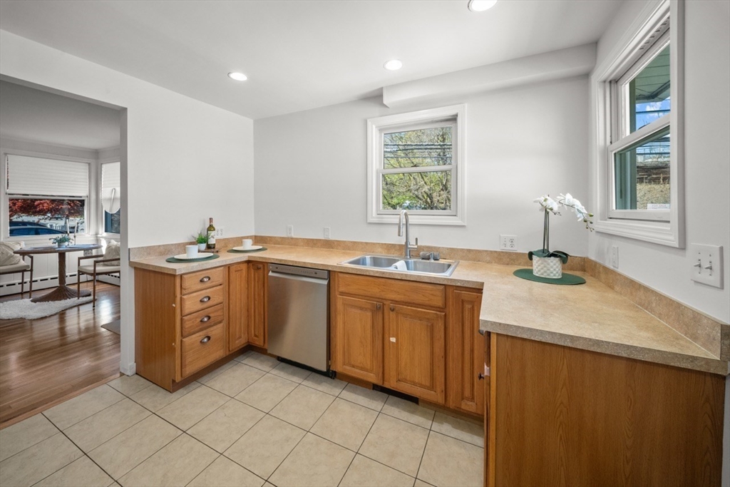 1180 Main Street, Unit 1 Waltham, MA 02451 - Photo 14 of 30 a kitchen with sink cabinets and window