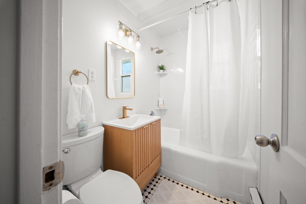 1180 Main Street, Unit 1 Waltham, MA 02451 - Photo 15 of 30 a bathroom with a sink a toilet and shower