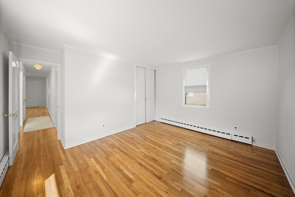 1180 Main Street, Unit 1 Waltham, MA 02451 - Photo 17 of 30 a view of an empty room and wooden floor