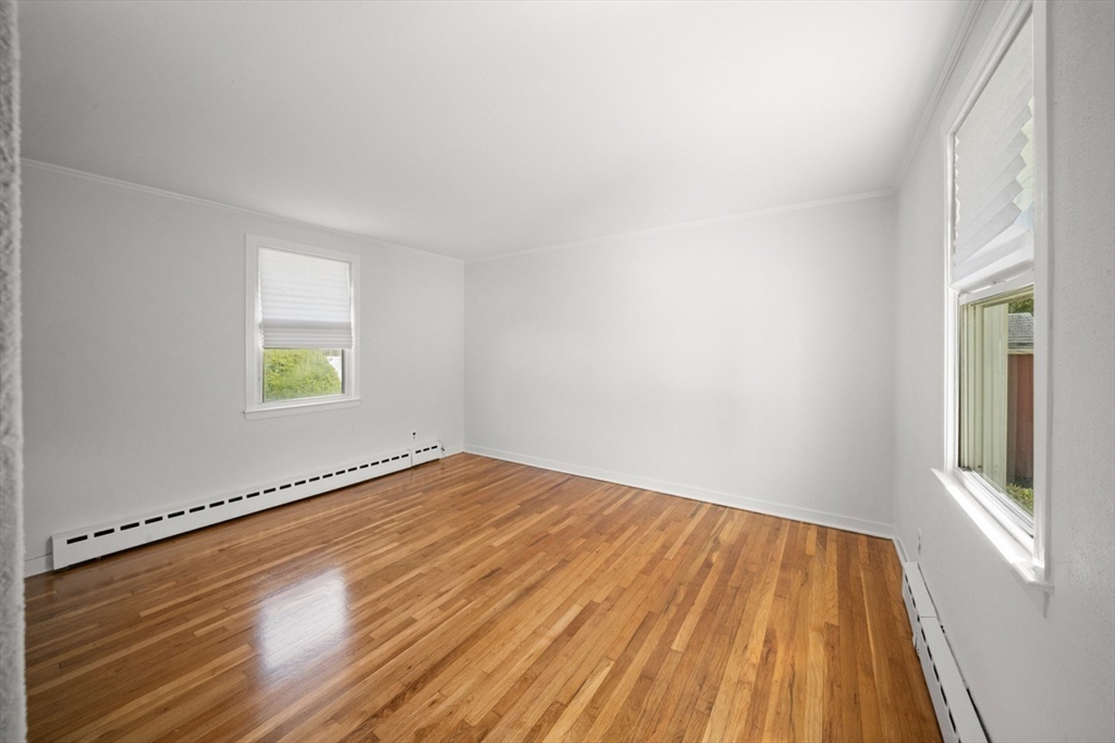 1180 Main Street, Unit 1 Waltham, MA 02451 - Photo 19 of 30 a view of an empty room with wooden floor and a window