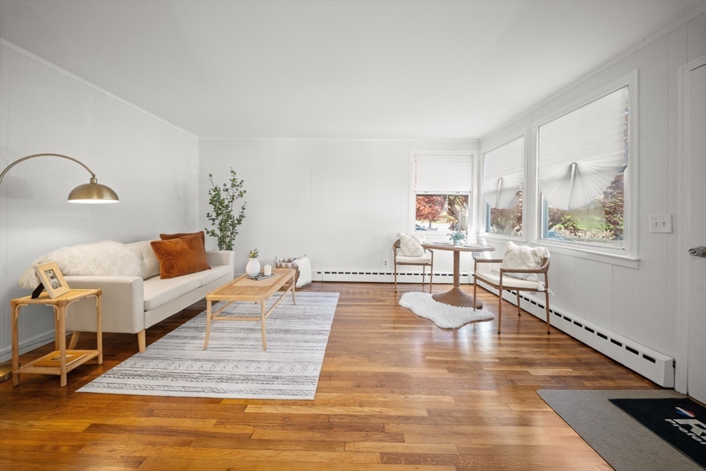 1180 Main Street, Unit 1 Waltham, MA 02451 - Photo 2 of 30 a living room with furniture and a wooden floor