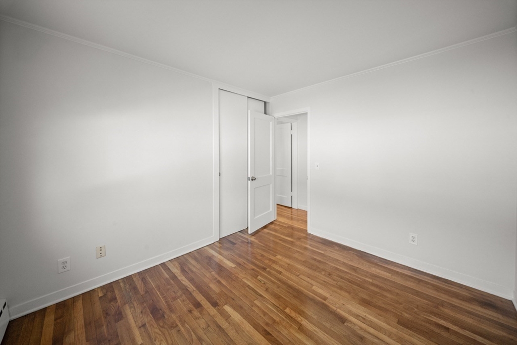 1180 Main Street, Unit 1 Waltham, MA 02451 - Photo 22 of 30 a view of an empty room with wooden floor