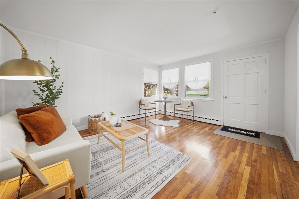 1180 Main Street, Unit 1 Waltham, MA 02451 - Photo 3 of 30 a living room with furniture and a wooden floor